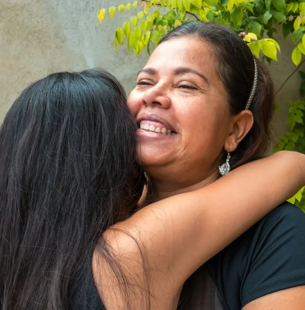 Teen hugging parent